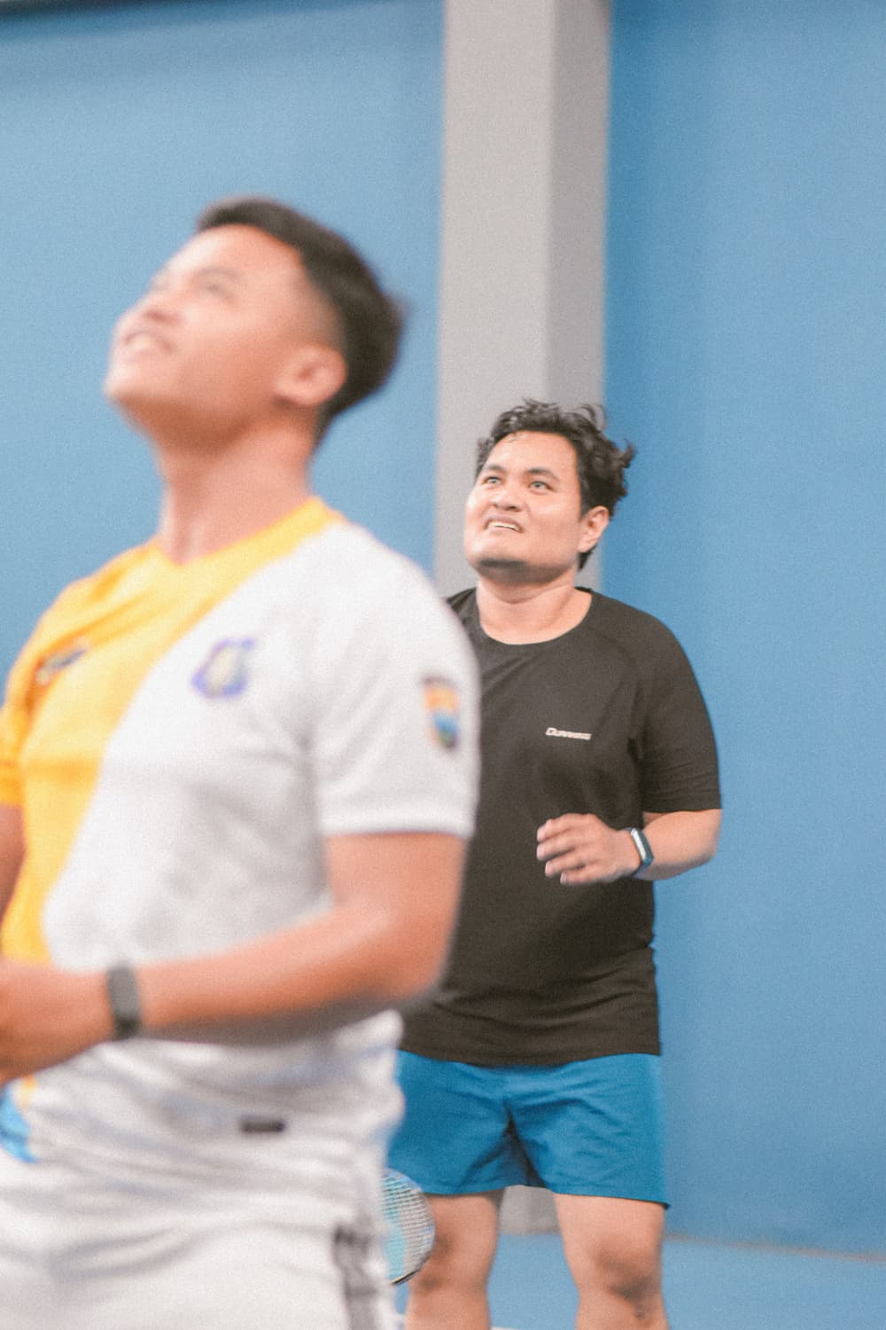 A close-up of a shuttlecock on the net.